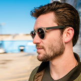 close up angle view of man wearing distil cooper sunglasses with matte crystal frames