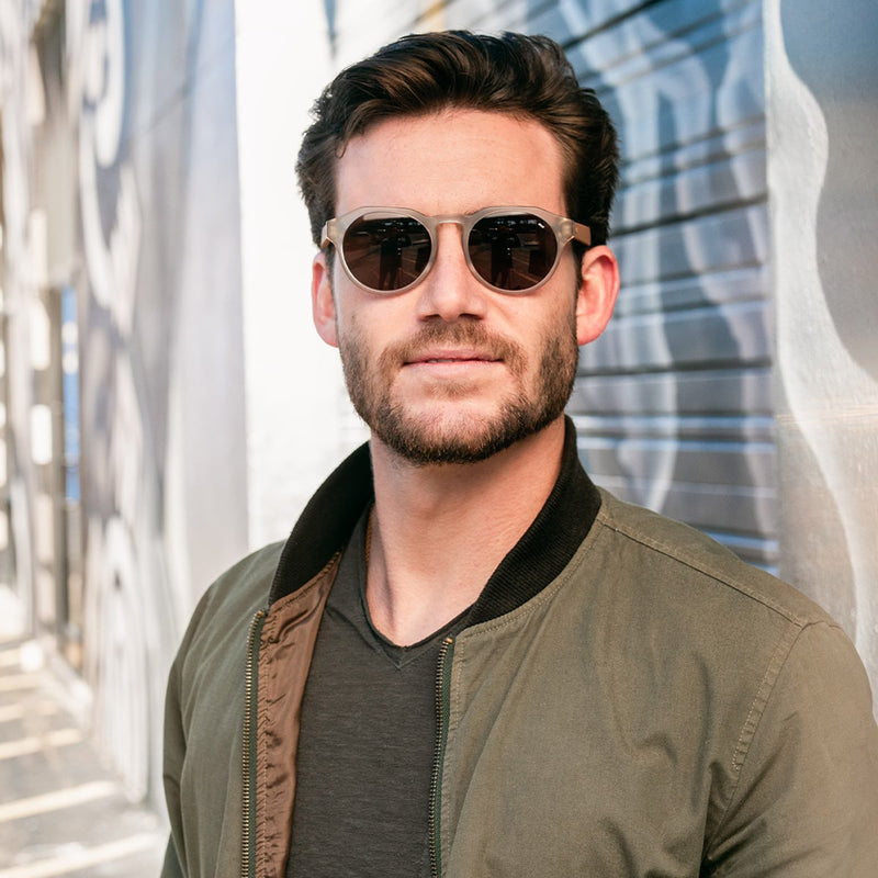 front view of man wearing distil cooper sunglasses with matte crystal frames and polarized lens