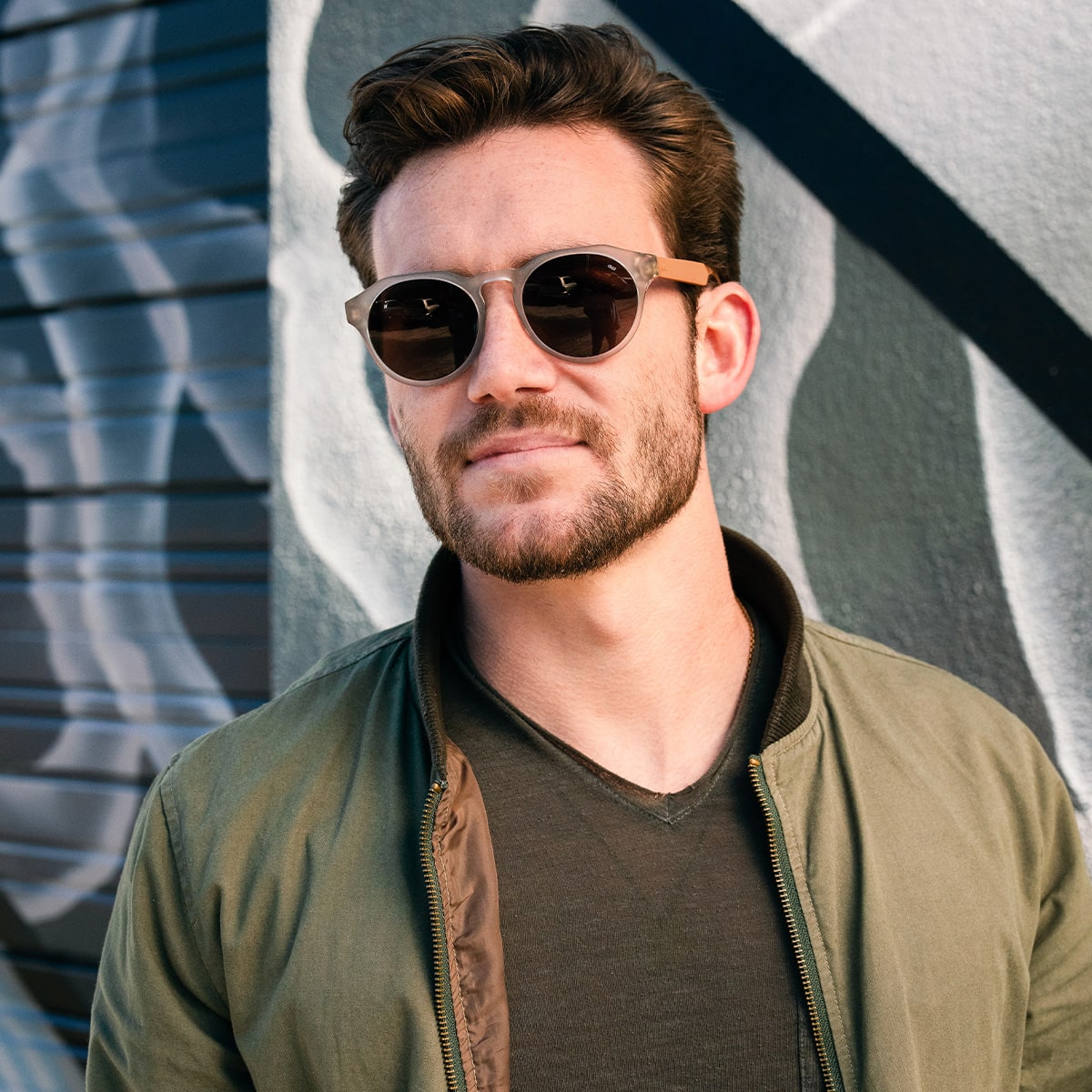 bearded man wearing distil cooper sunglasses with matte crystal frames and amber polarized lens