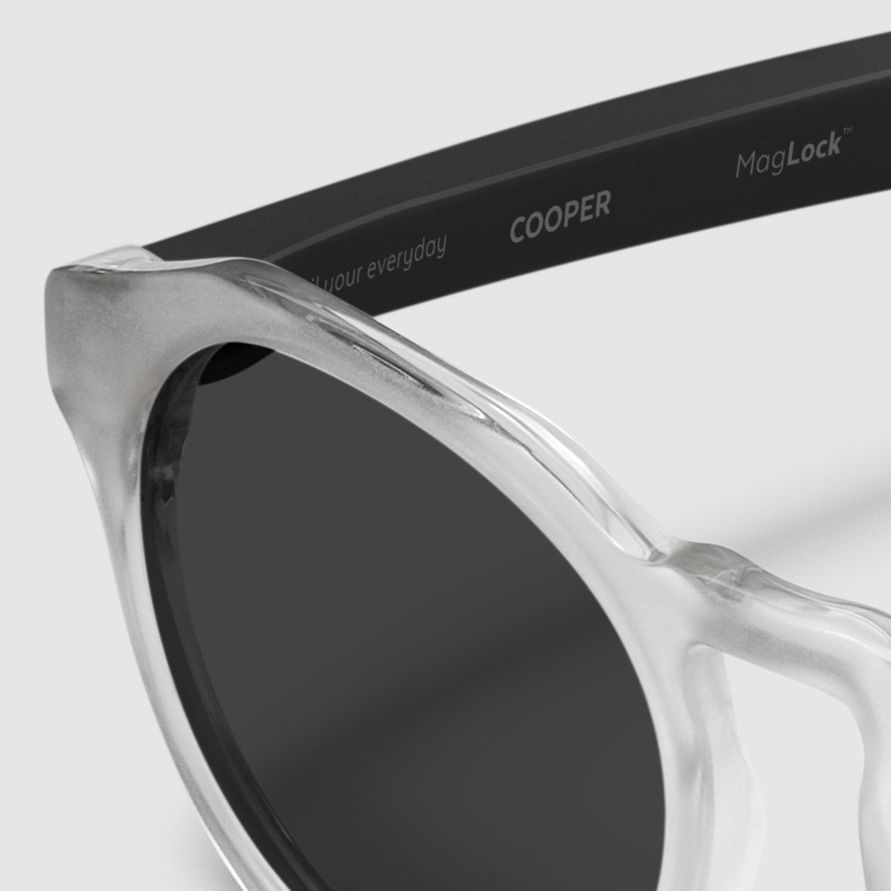 close up view of distil cooper sunglasses with matte crystal frames and polarized lens