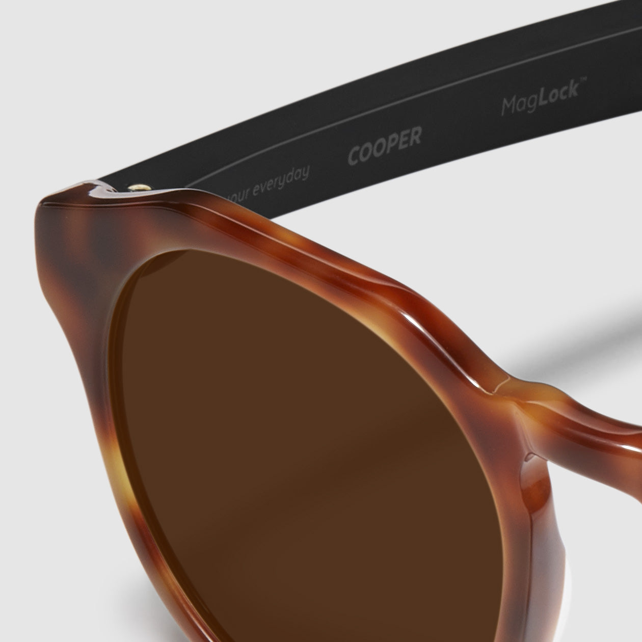 close up view of distil cooper sunglasses with tortoise frames and amber polarized lens