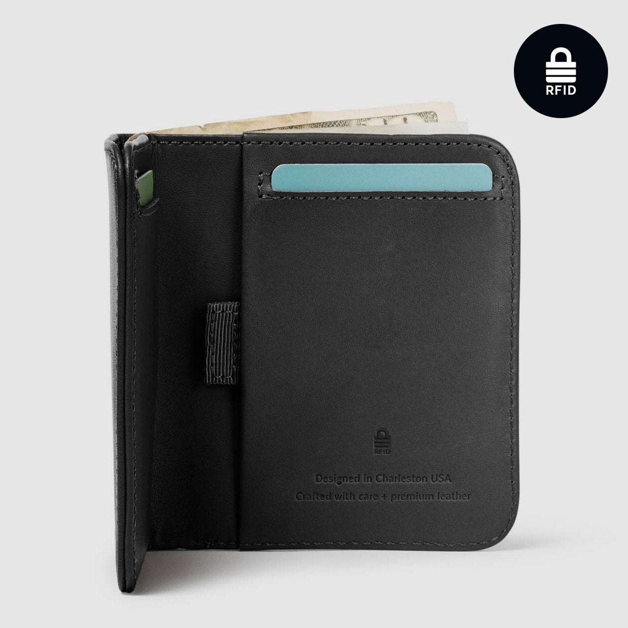 opened distil ink black billfold wallet with rfid protection, a card and paper bill protruding